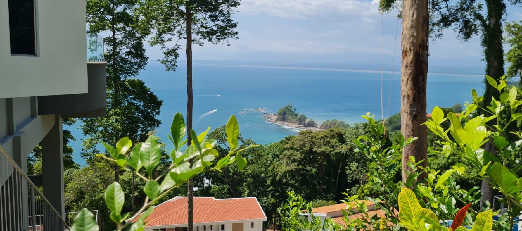 Punta Leona oceanview lot in a gated hilltop community, fully titled and steps from white-sand beaches with utilities ready to build.