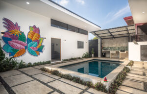 Herradura beachside dual-home property for sale. Turnkey furnished homes near Marina Los Sueños with private pool, parking, and no HOA fees.