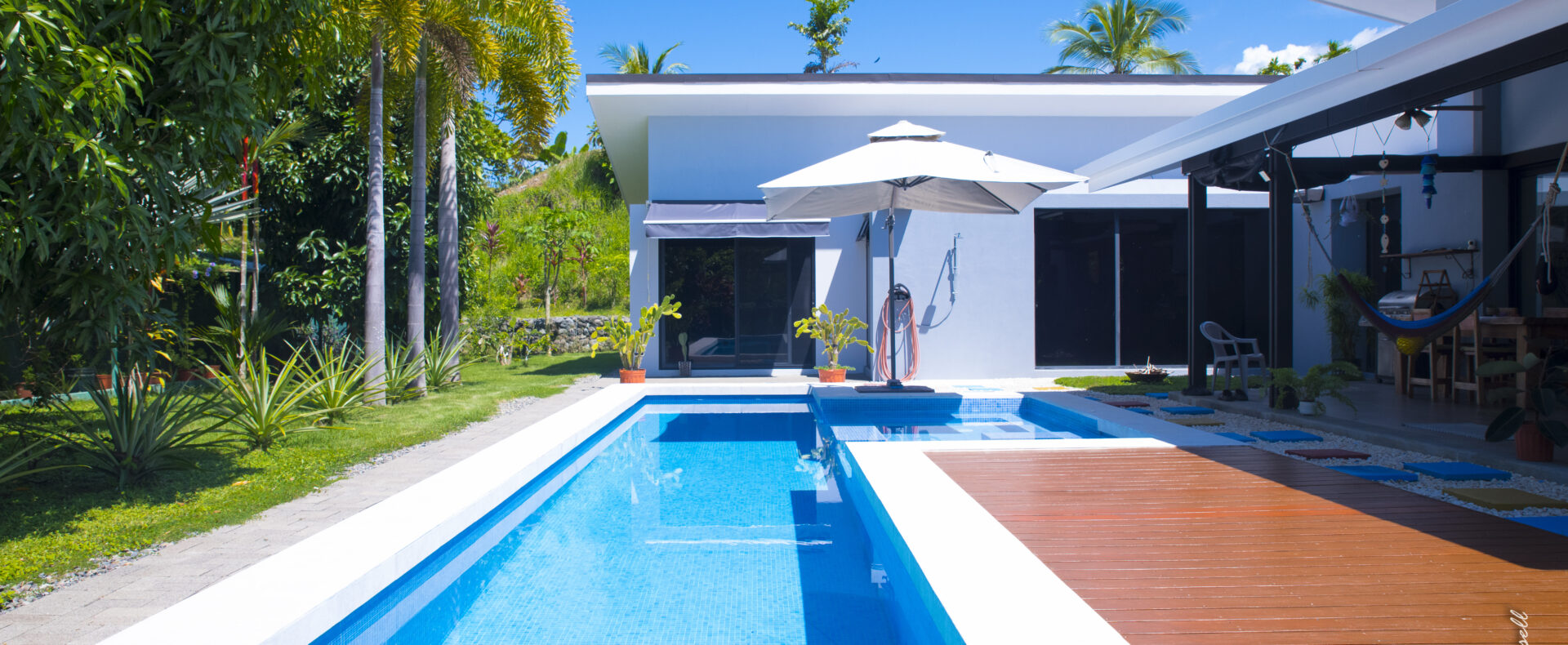 Bejuco Beach home for sale. Modern single-story residence with pool, garden, garage, and elegant design. Minutes from the coast and shopping.