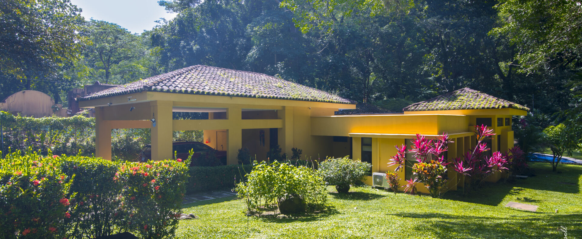 Tarcoles home for sale beside a peaceful creek. Four bedrooms, private pool, lush gardens, and nature views just minutes from the beach.