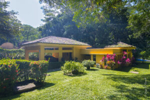 Tarcoles home for sale beside a peaceful creek. Four bedrooms, private pool, lush gardens, and nature views just minutes from the beach.